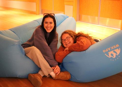 Participants pose for a photo on inflatable couches