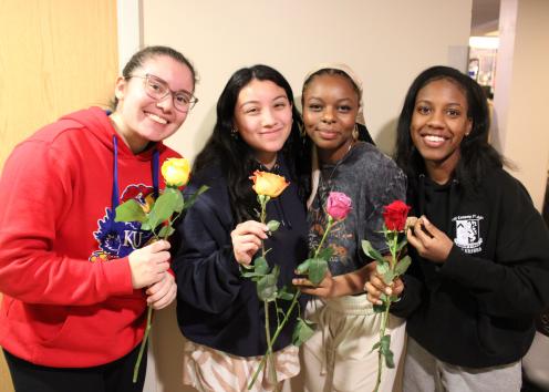 Participants pose with roses