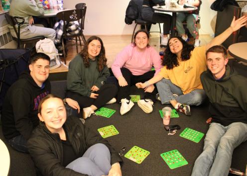 Participants sit together in a circle with their Bingo boards