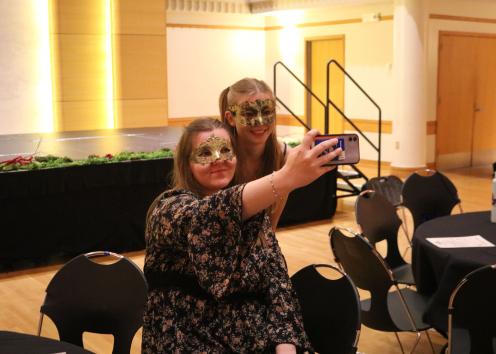 Participants take a selfie with masquerade masks on