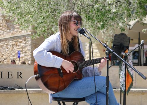 Gracie Hughes performing with her guitar