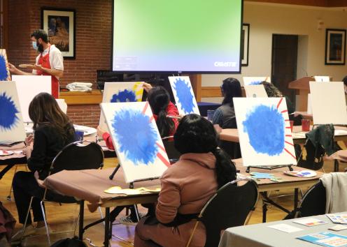 Participants follow instructions to draw a Jayhawk at the event